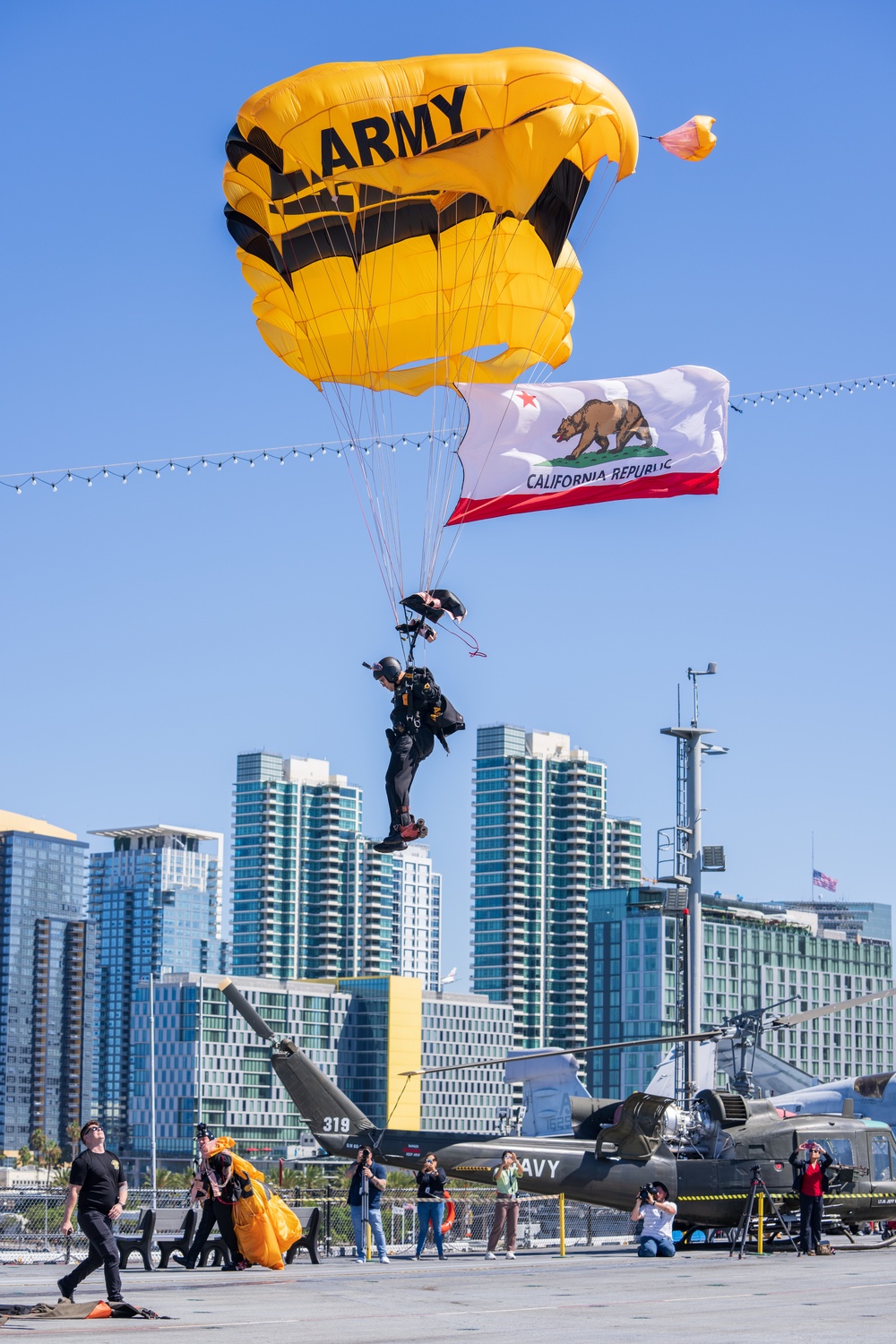 The U.S. Army Parachute Team jumps onto the USS Midway in San Diego