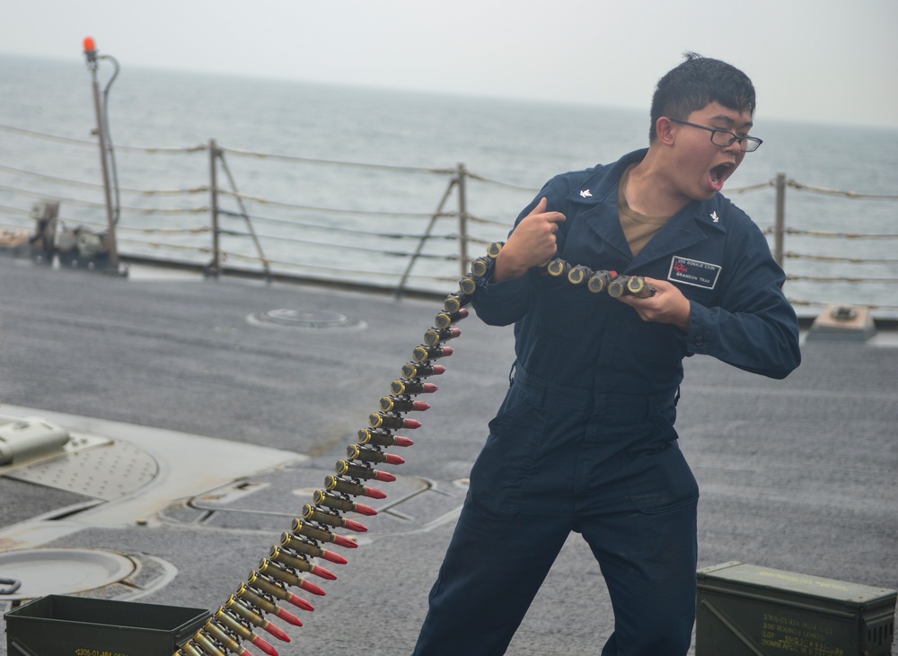 Sailors on USS Lassen Load Ammunition