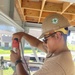 Builder 3rd Class Carlos Hernandez, drills holes in nailing boards for the Richardson Multipurpose Facility.