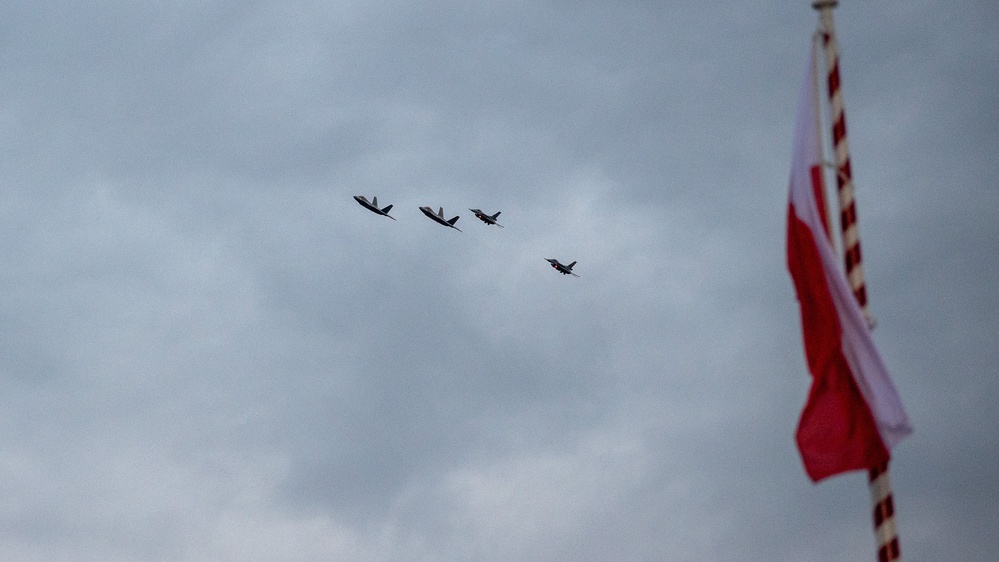 U.S. F-22s fly alongside Polish F-16s during the WWII Commemoration in Poland