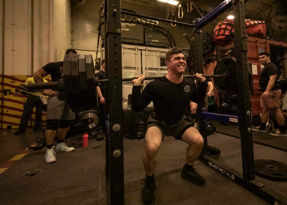 US Navy Sailors Participate in a Squat Challenge Aboard USS George H.W. Bush