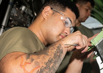 Aircraft maintainers work on E-8C Joint STARS engine