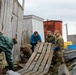 Alaska National Guardsmen in Joint Task Force-Bethel clear storm debris in Newtok, Alaska