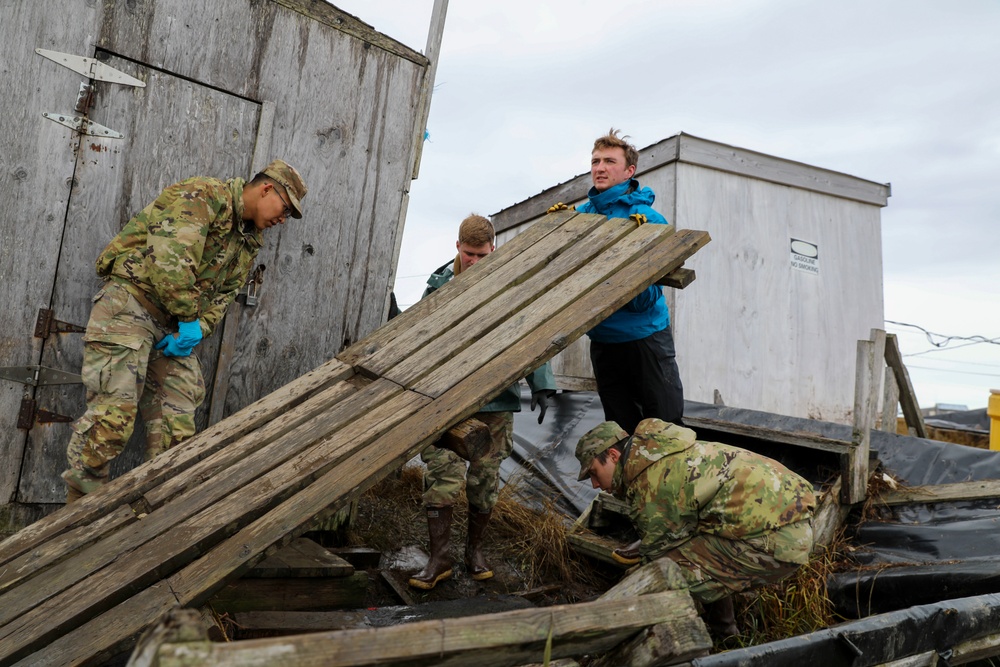 Alaska National Guardsmen in Joint Task Force-Bethel clear storm debris in Newtok, Alaska