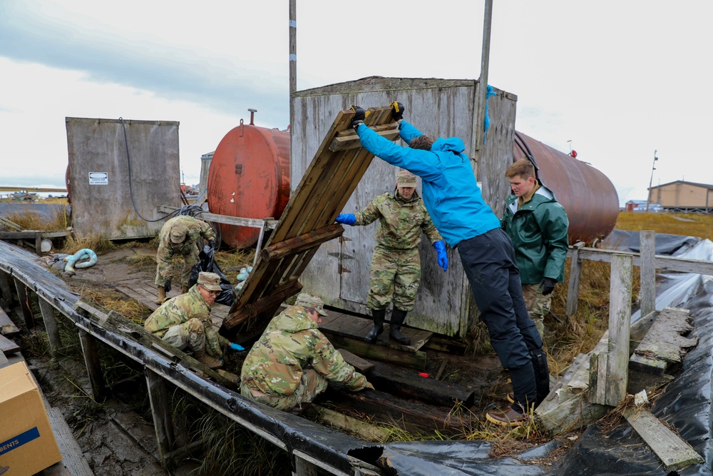 Alaska National Guardsmen in Joint Task Force-Bethel clear storm debris in Newtok, Alaska