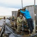 Alaska National Guardsmen in Joint Task Force-Bethel clear storm debris in Newtok, Alaska