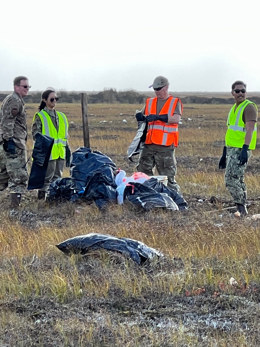 Service members of Joint Task Force-Bethel clear storm debris in Nightmute, Alaska for Operation Merbok Response