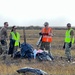 Service members of Joint Task Force-Bethel clear storm debris in Nightmute, Alaska for Operation Merbok Response