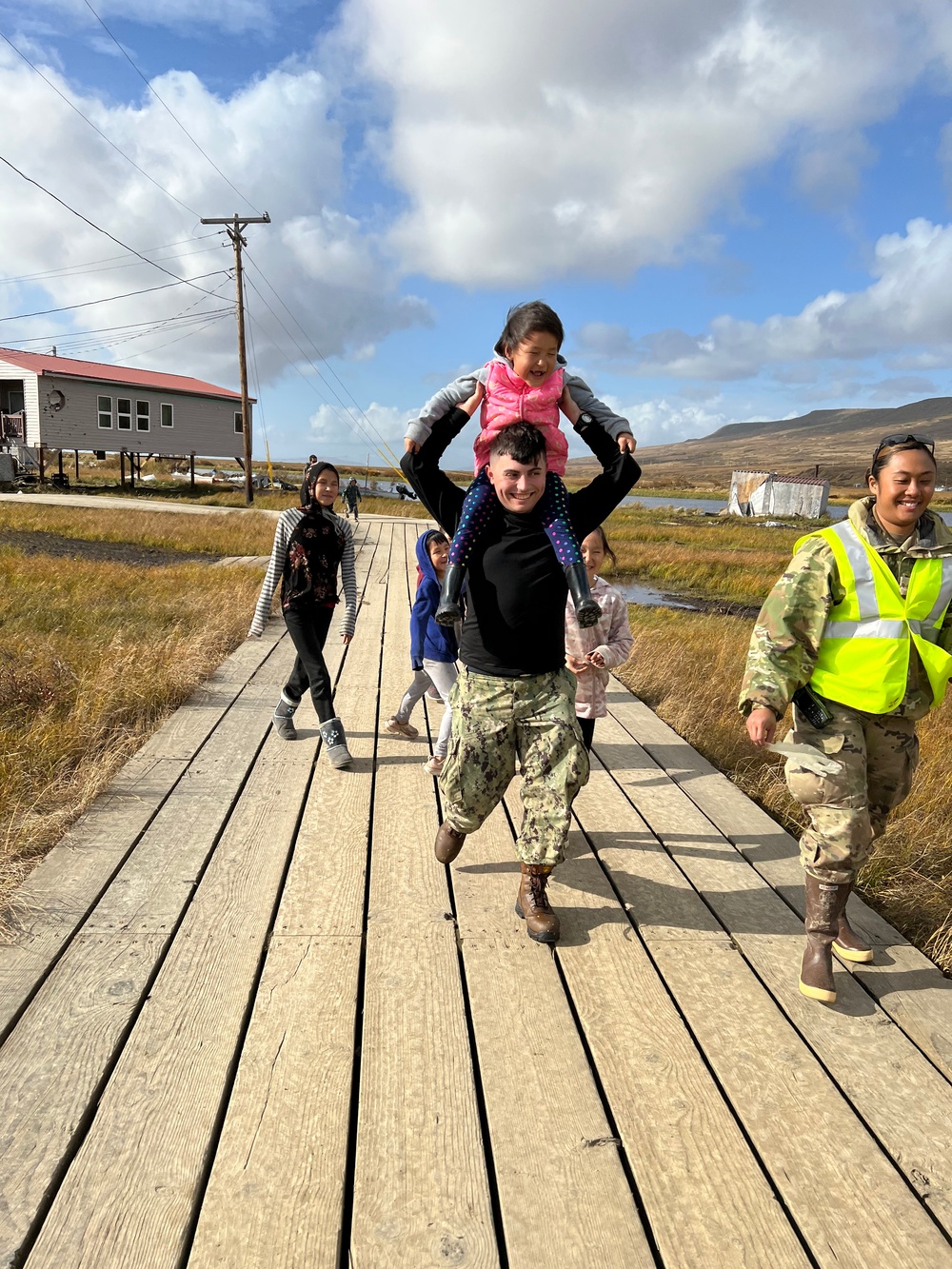 Service members of Joint Task Force-Bethel clear storm debris in Nightmute, Alaska for Operation Merbok Response