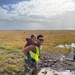 Service members of Joint Task Force-Bethel clear storm debris in Nightmute, Alaska for Operation Merbok Response