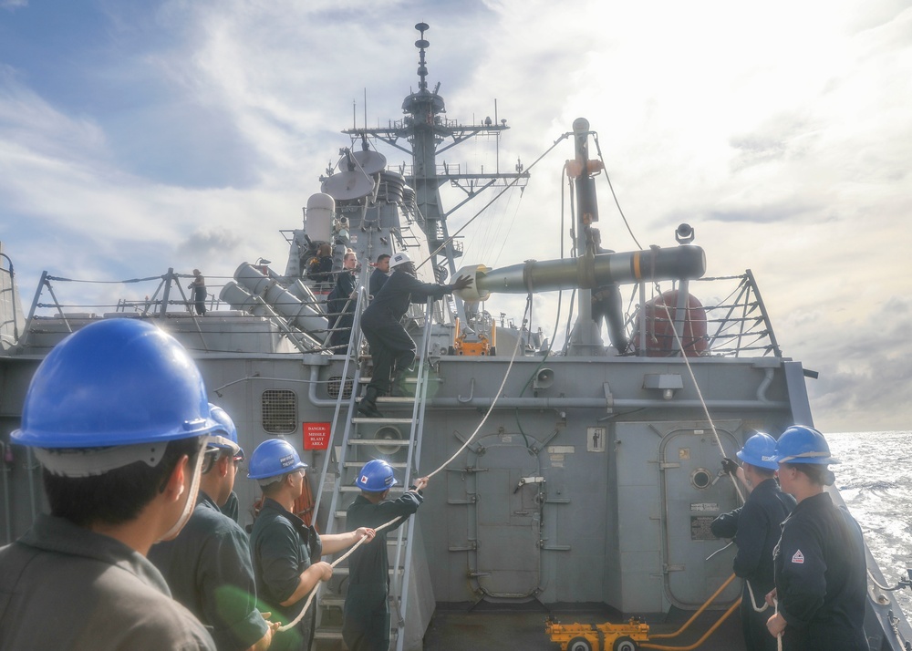 Sailors Hoist Torpedo