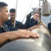 Sailors Move Torpedo