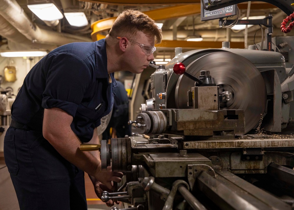 Machinery Repairman Shaves Brass Pipe