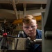 Machinery Repairman Shaves Brass Pipe