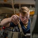 Machinery Repairman Brushes Down Machinery