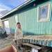 A service member of the Alaska Organized Militia repairs infrastructure for Operation Merbok Response