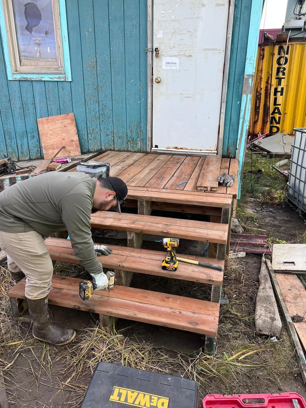 A service member of the Alaska Organized Militia repairs infrastructure for Operation Merbok Response