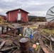 A service member of the Alaska Organized Militia clears storm debris for Operation Merbok Response