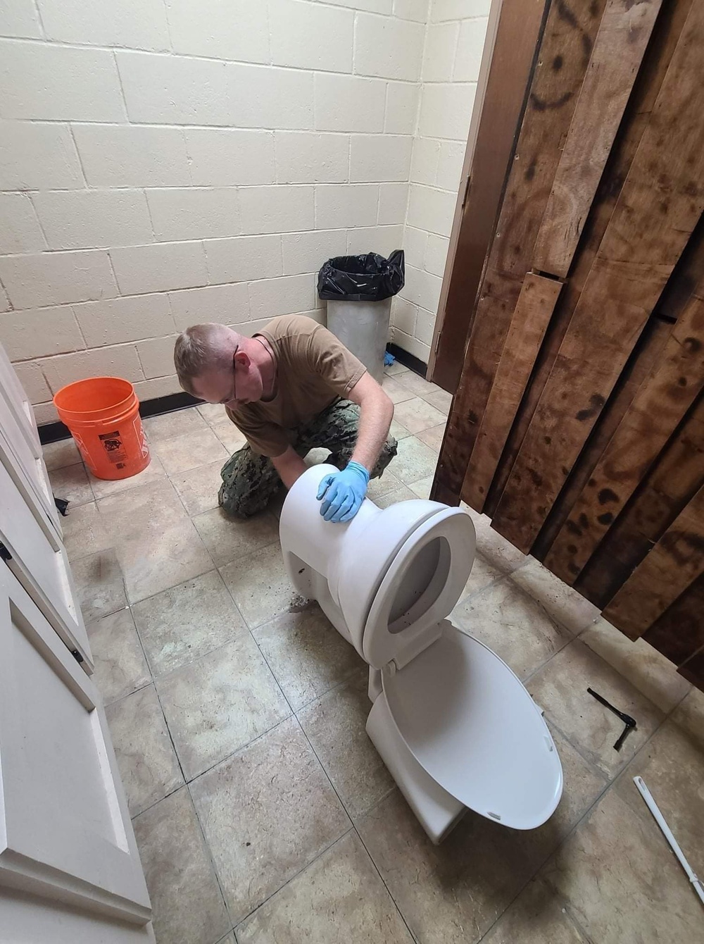 NMCB-11 Seabee installs wax rings in support of the camp maintenance shop