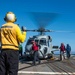 U.S. Sailors Refuel An MH-60R Sea Hawk Helicopter