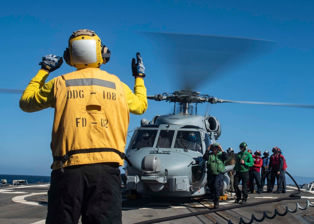 U.S. Sailors Refuel An MH-60R Sea Hawk Helicopter