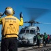 U.S. Sailors Refuel An MH-60R Sea Hawk Helicopter