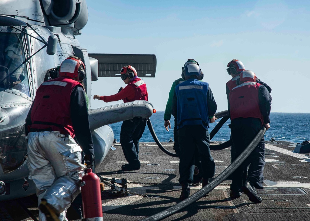 U.S. Sailors Refuel An MH-60R Sea Hawk Helicopter