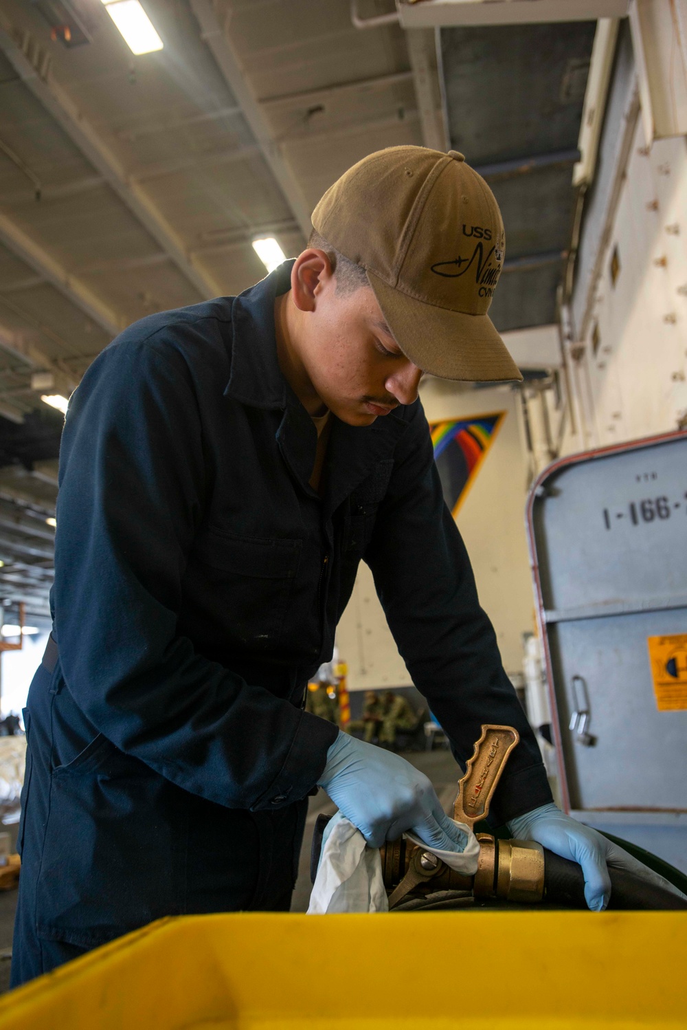 U.S. Navy Sailor Polishes Nozzle