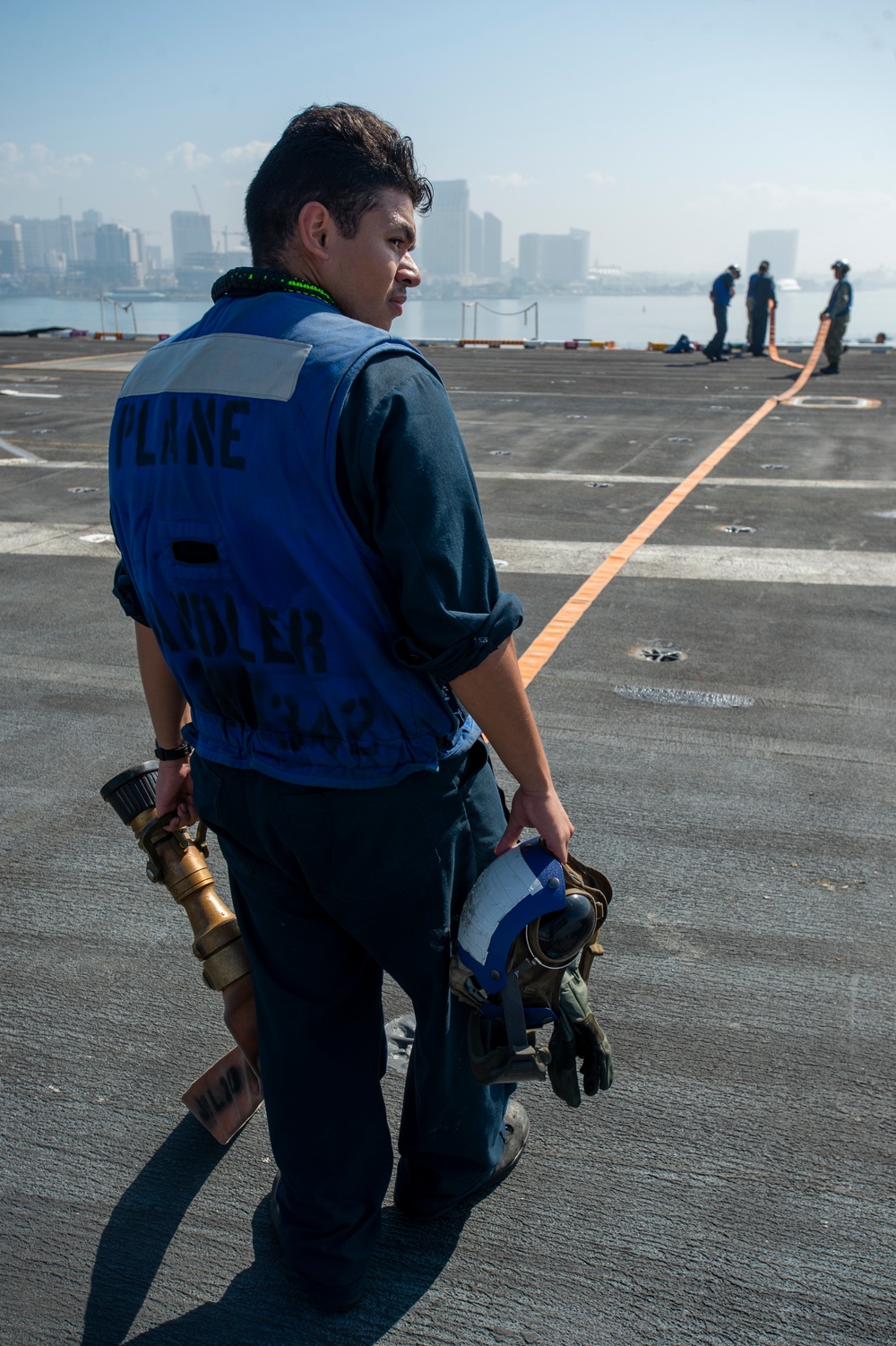 Sailor Stows Fire Hose