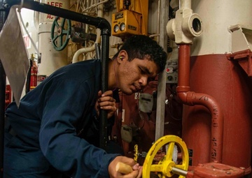 U.S Sailor Cleans Valve Labels