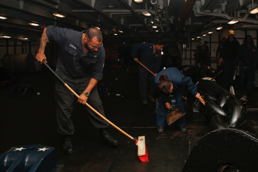 Abraham Lincoln Sailors clean the deck