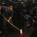 Abraham Lincoln Sailors clean the deck