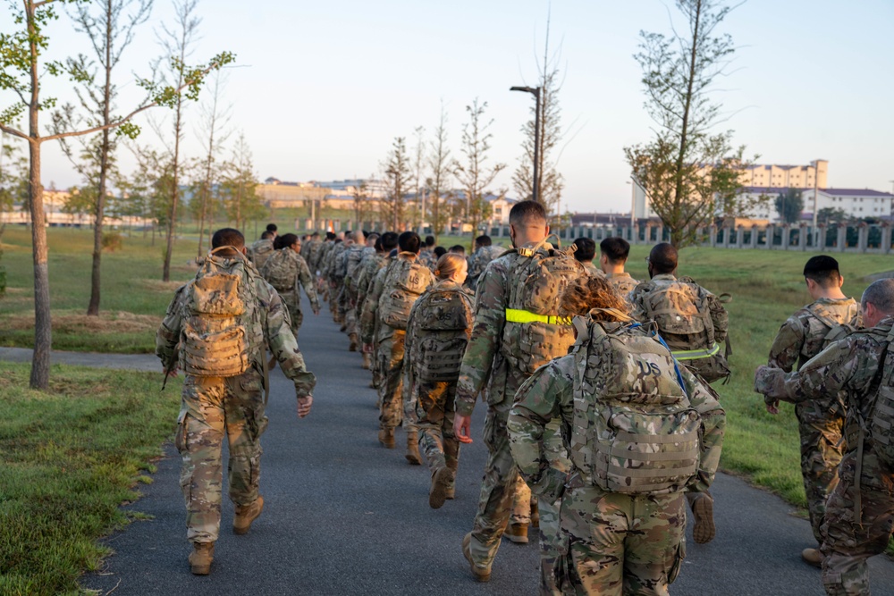 Soldiers from 1st Signal Brigade go on a ruck march for physical training in the morning.