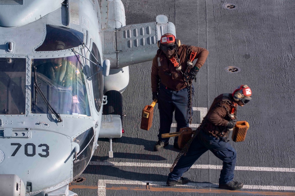 U.S. Navy Sailors Prepare An MH-60R Sea Hawk Helicopter For Take-Off