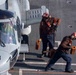 U.S. Navy Sailors Prepare An MH-60R Sea Hawk Helicopter For Take-Off