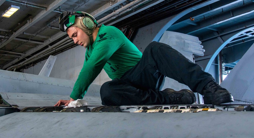 USS Ronald Reagan (CVN 76) Sailors in the AIMD tunnel and hangar bay