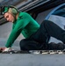 USS Ronald Reagan (CVN 76) Sailors in the AIMD tunnel and hangar bay