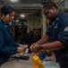 USS Ronald Reagan (CVN 76) Sailors in the AIMD tunnel and hangar bay