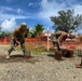 Seabees break through old welds on steel plate to repurpose them to be welded to the bottom of the new living units at Camp Katuu.