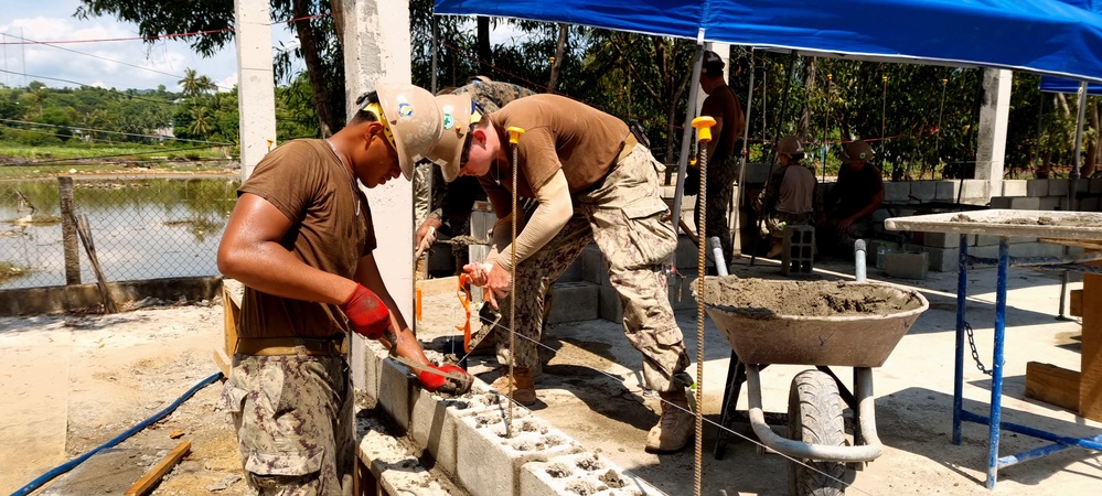 Seabees in Phước Hòa, Vietnam lay the first of 15 courses of Concrete Masonry Units block for the Phước Hòa primary school.