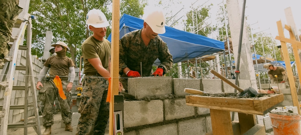 Marine's with 7th Engineer Support Battalion laying Concrete Masonry Units block courses for the Phước Hòa primary school in Vietnam.