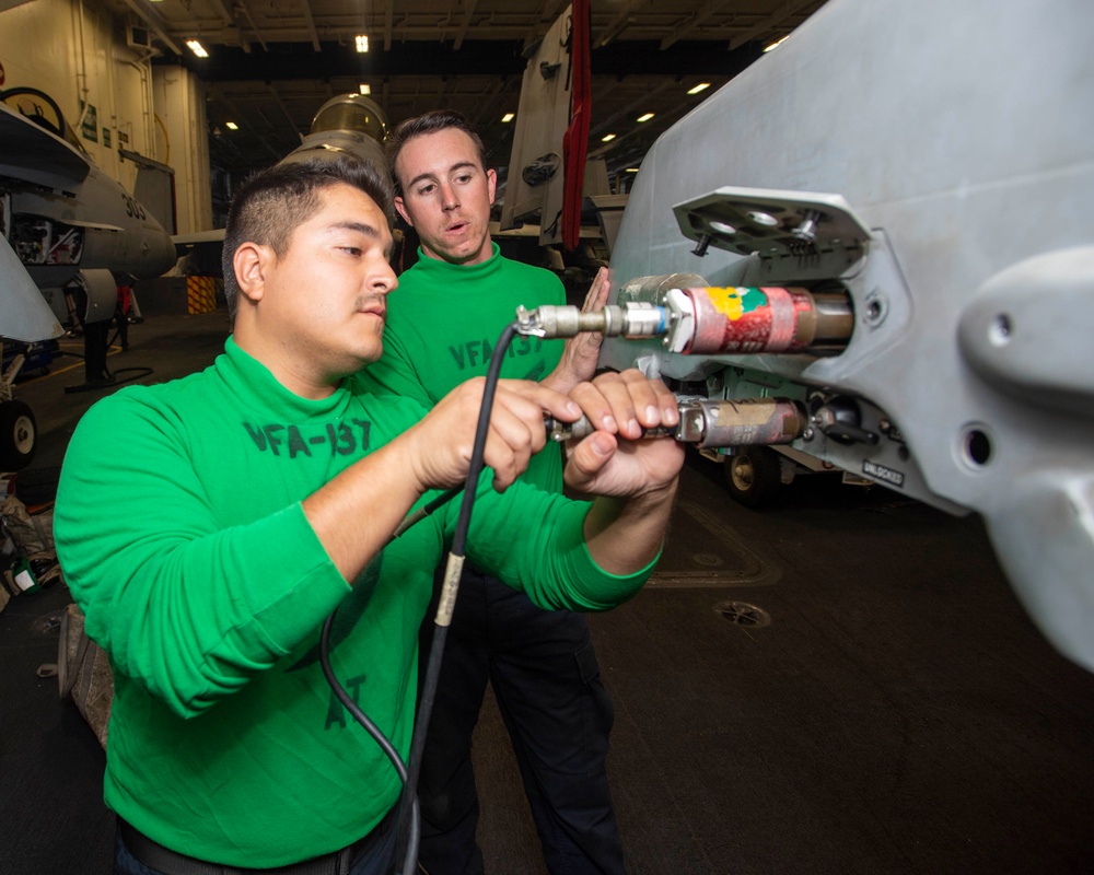 Sailor Connects Cable To An Aircraft