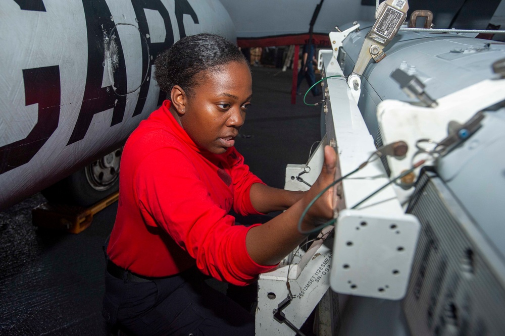 Sailor Removes Pod From Aircraft Wing