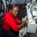 Sailor Removes Pod From Aircraft Wing