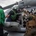 U.S. Sailors Load Radar Equipment Into An MH-60R Sea Hawk Helicopter