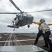 U.S. Sailors Direct An MH-60S Sea Hawk Helicopter