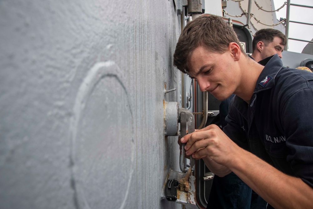 U.S. Sailor Conducts Maintenance On A Watertight System