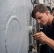 U.S. Sailor Conducts Maintenance On A Watertight System