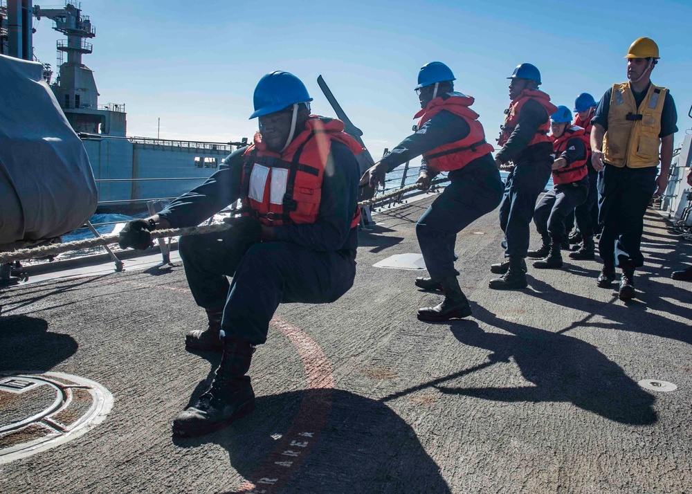 U.S. Sailors Heave The Line During An Underway Replenishment