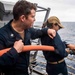 U.S. Sailors Conduct Routine Maintenance On Fire Hoses